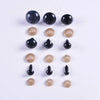 A collection of plastic safety eyes in various sizes and colors, including black, brown, and clear.