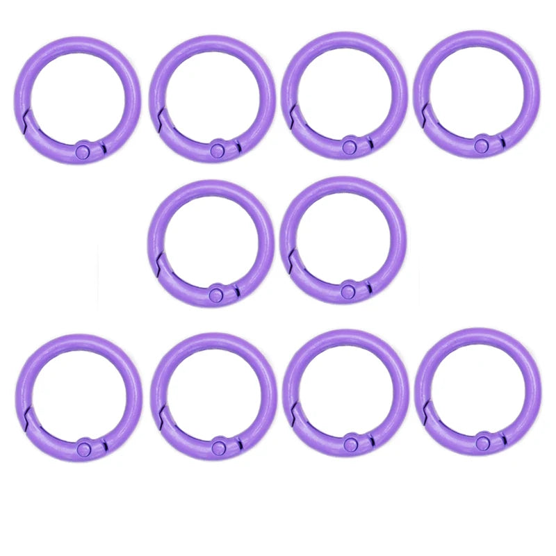 A set of eight purple alloy snap hook keychain clips arranged in two rows.