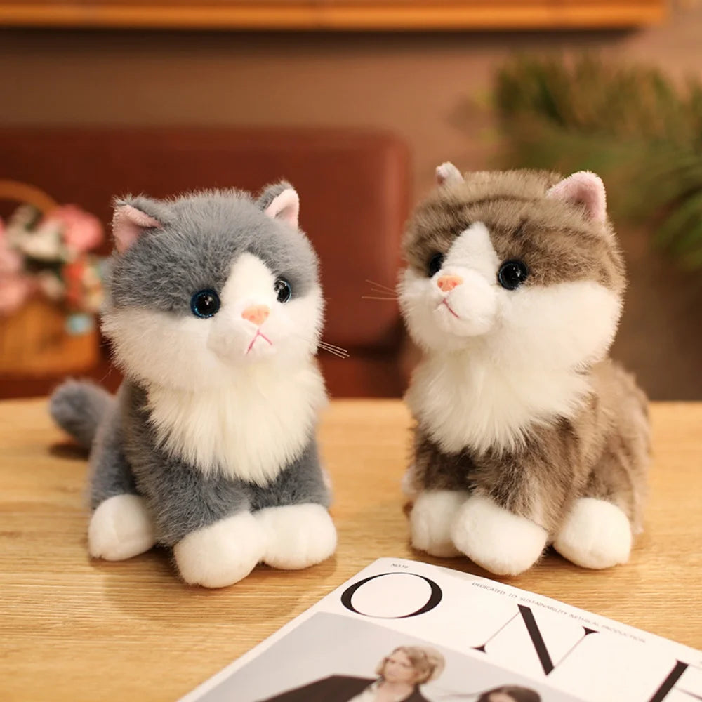 A pair of adorable sitting kitten plush toys in gray and white colors.