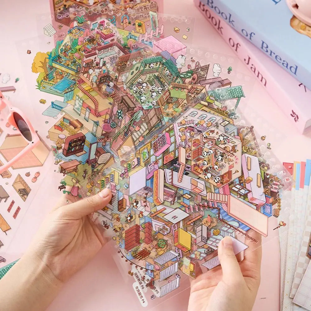 A hand holds up a colorful sticker book featuring 3D cabin scenes and various building elements on pink paper.