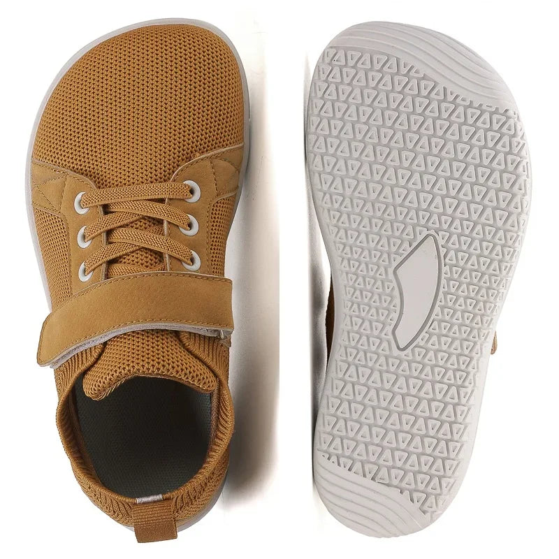 A pair of tan minimalist barefoot sneakers shown from the top and bottom views.