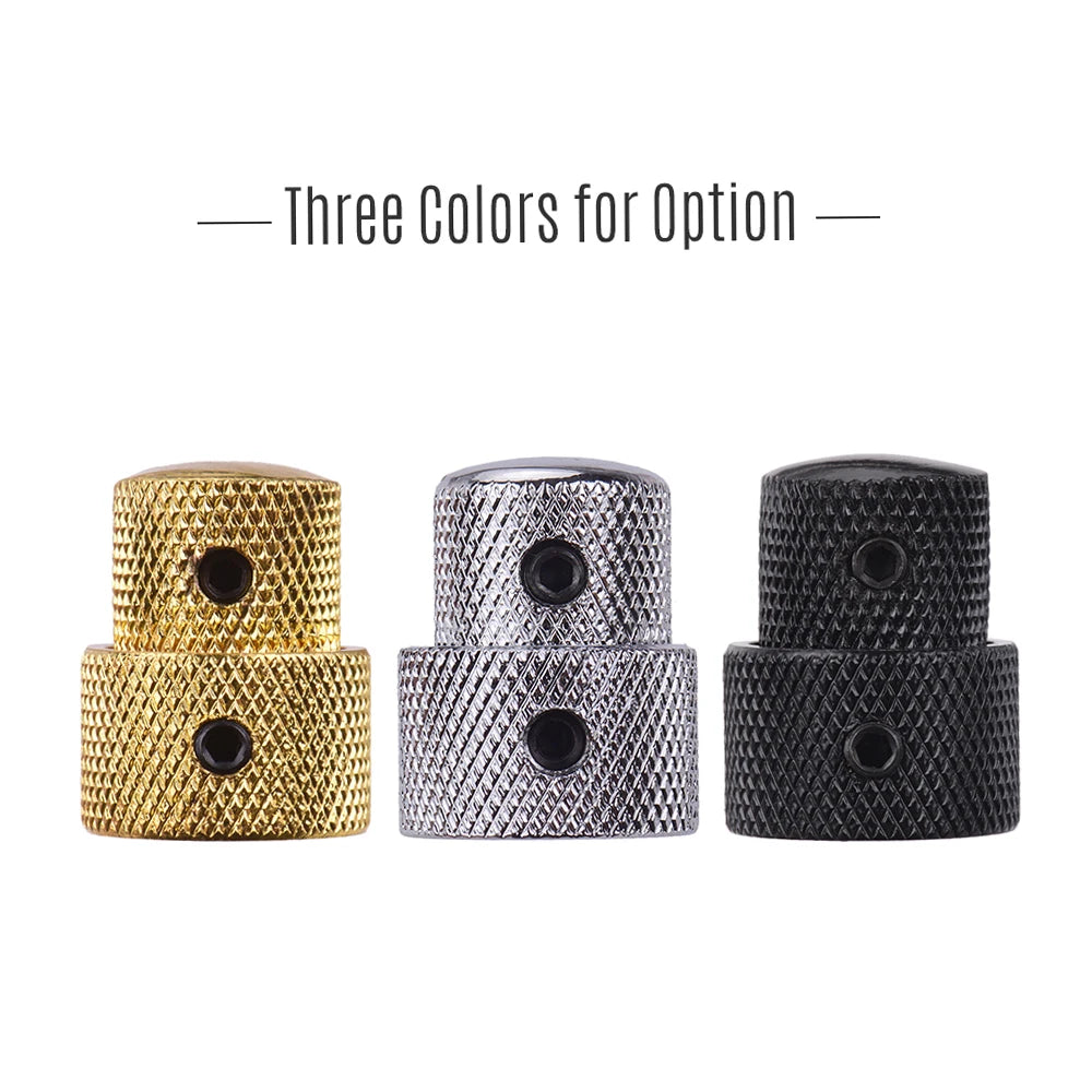 Three stacked control knobs for electric guitar and bass in gold, silver, and black finishes.
