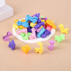 A pile of colorful, squishy animal and dinosaur sensory stress bracelets for kids scattered on a light background.