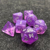 A pile of seven iridescent purple acrylic polyhedral dice resting on a dark, textured surface.