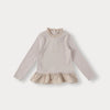 A light beige knit sweater with a ruffled collar and a matching ruffled hem, shown flat lay.