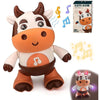 An orange and white plush toy of a cow with musical notes and lights, standing in a playful pose.