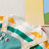 A striped dinosaur two-piece outfit set featuring white, yellow, and green stripes on a light background.