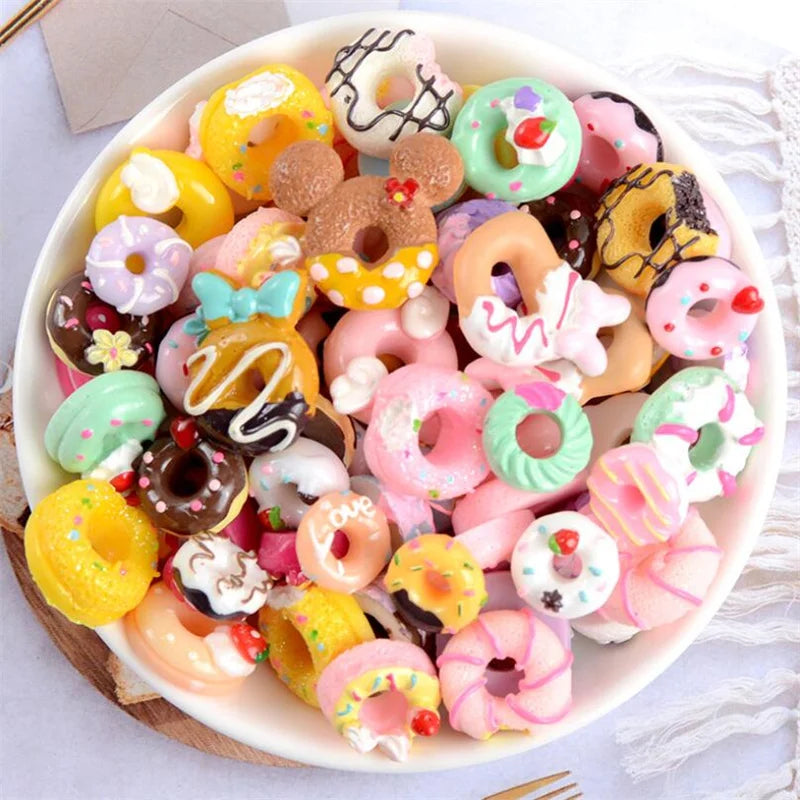 A bowl filled with assorted colorful donut-shaped resin candies for DIY crafts and jewelry making