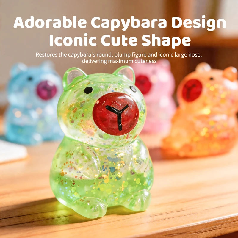 A transparent, glittery green capybara squishy toy sitting on a wooden surface.