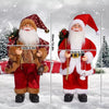 A figurine of Santa Claus in a red suit and white beard standing in the snow.