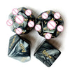 A set of black dice and a playful red metal table bell for couples' games