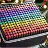 A close-up view of a large set of 12 color permanent art markers arranged in a grid inside a black case.