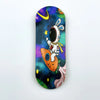 A wooden fingerboard deck featuring a space theme with a white rabbit astronaut and colorful planets.