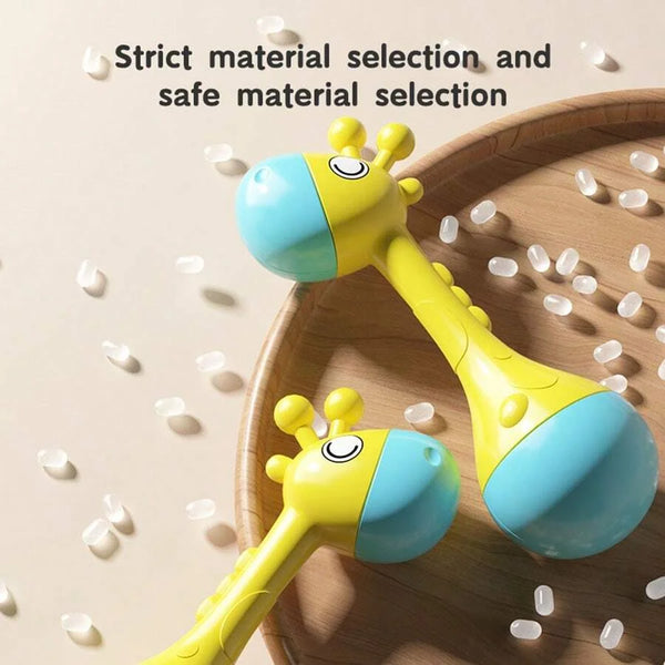 Yellow and blue soft plastic animal rattle resting on a wooden surface.