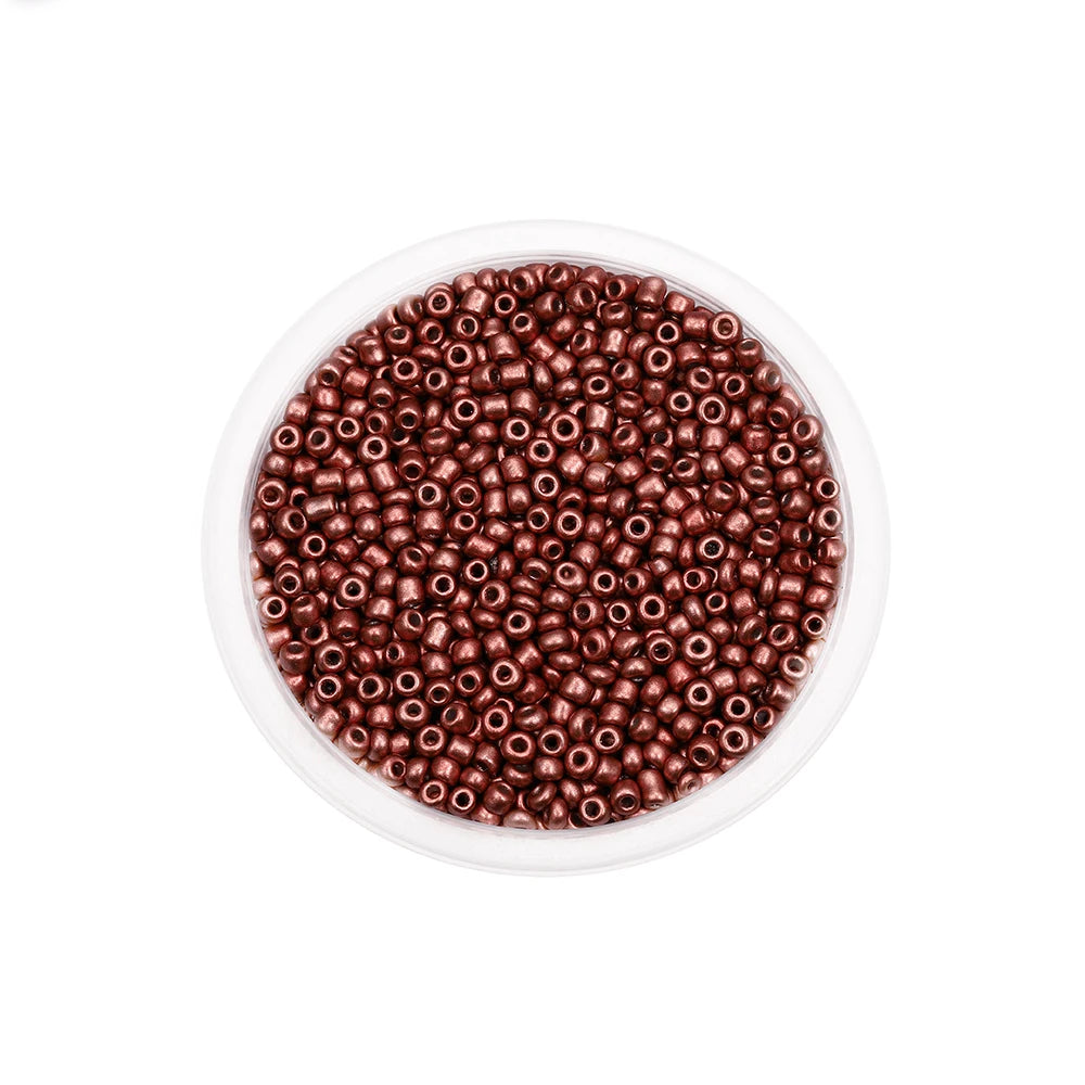 A clear container filled with small, round, reddish-brown glass seed beads for jewelry making.