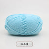 A ball of light blue pre-dyed milk cotton yarn used for knitting and crochet.