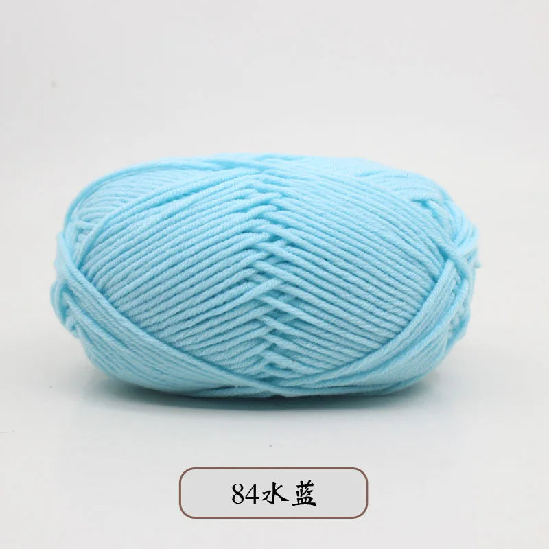 A ball of light blue pre-dyed milk cotton yarn used for knitting and crochet.