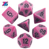 A set of pink and black polyhedral dice including a d20, d8, d10, and d12.