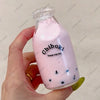 A pink liquid in a glass bottle labeled Chiboki is held by a hand.