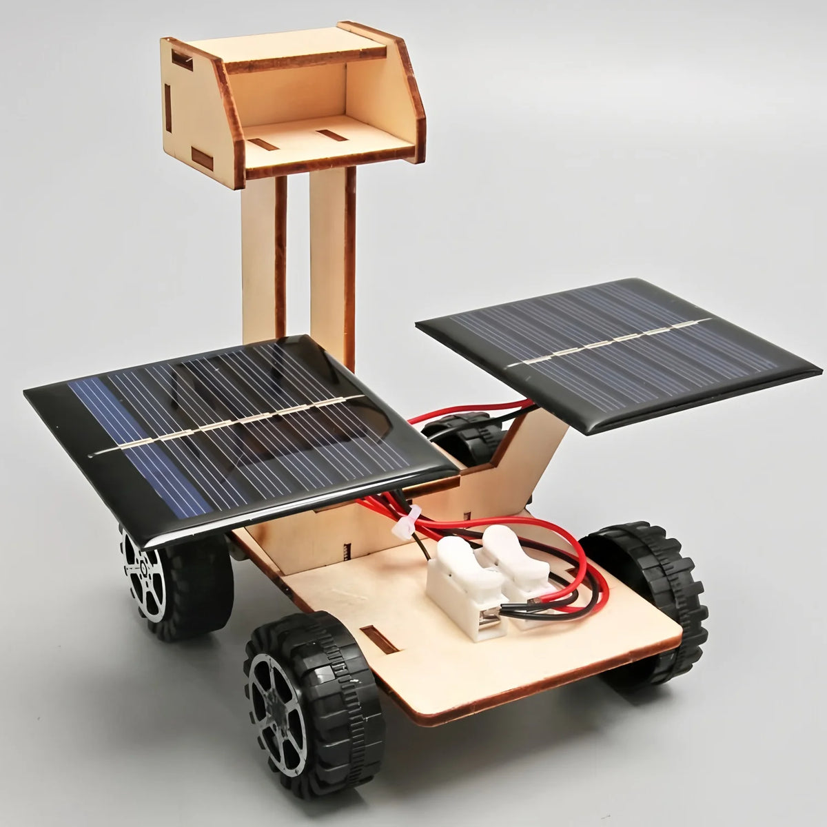A wooden model kit of a solar-powered lunar rover featuring solar panels and wheels.