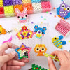Hands are assembling colorful water beads into various shapes and patterns for DIY crafts.