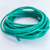 A coil of green flexible silicone tinned copper wire with multiple AWG gauges coiled on a white surface.