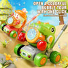 A green and orange kids bubble machine with lights and wheels is shown on a yellow surface.