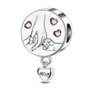 A silver heart charm bead featuring a detailed face design and a small pink zircon gemstone.