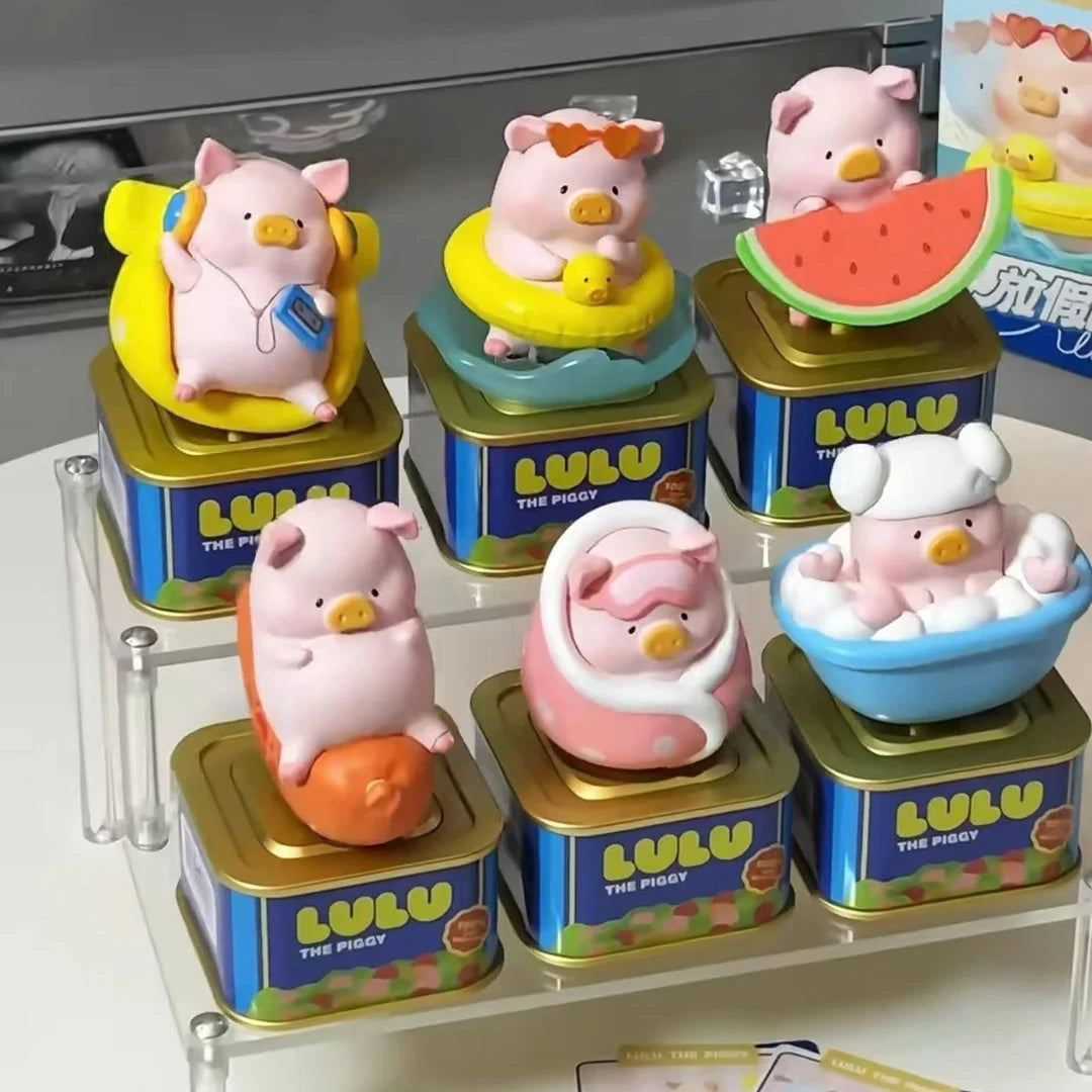 A collection of pink and white pig figurines in various colors and sizes displayed in gold and blue boxes.