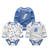 A set of three blue and gray cotton baby bodysuits with long sleeves featuring a dinosaur design.