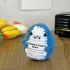 Handcrafted crochet shark doll with a white and blue body and an emotional support tag