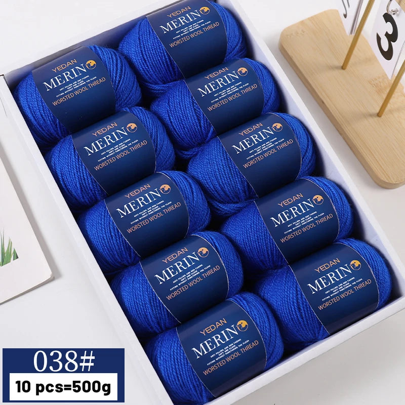 A box containing 10 skeins of blue YEDAN MERIN worsted wool thread yarn for knitting projects.