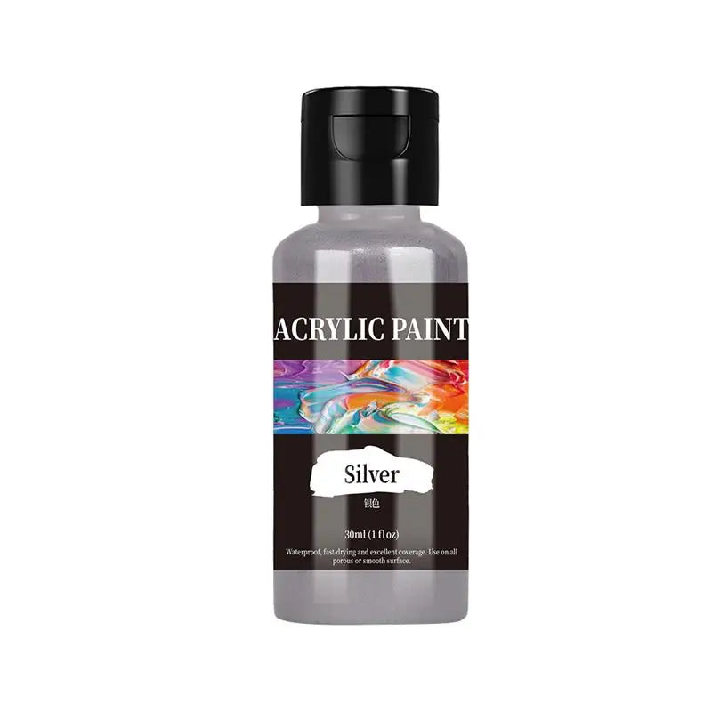 A dark glass bottle of silver acrylic paint with a black cap and a colorful swirl of paint visible through the liquid.