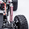 A close-up of a black metal CVD drive and tire assembly for an RC crawler truck.