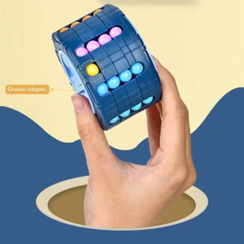 A hand holds a blue 3D rotating slide puzzle cube filled with colorful balls, demonstrating a groove adapter.