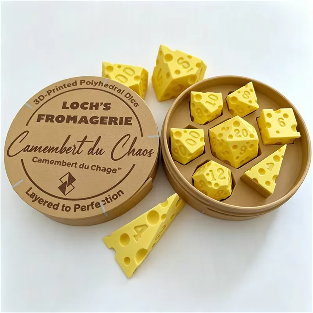 A set of yellow polygonal cheese dice inside a cardboard container with a label for Loch's Fromagerie