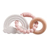 A set of pink and natural wood silicone teethers, including a rainbow arch and a ring, for babies.