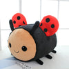 A cute plush toy of a bee with ladybug spots, featuring black and orange colors.