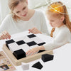 A young girl is playing with a wooden 3D block puzzle cube and storage case on a white table.