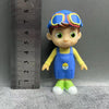 A playful cartoon PVC figurine of a boy dressed in a watermelon school bus design with blue and yellow clothing.