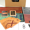 A collection of orange playing cards and game components are displayed next to a brown box featuring the title HITLER.