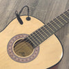 A light-colored acoustic guitar with a clip-on condenser microphone attached via a gooseneck