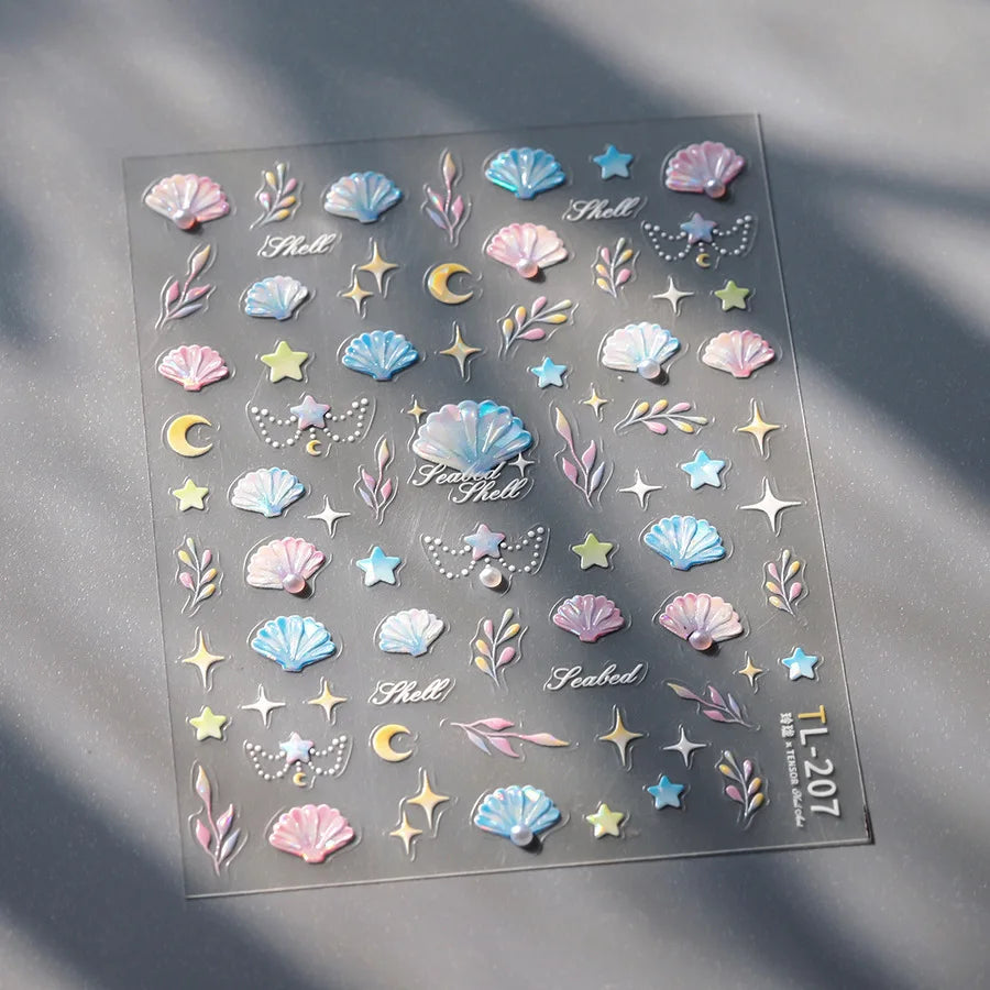 A sheet of 5D bronzing gothic nail art stickers featuring seashells, stars, and celestial elements.