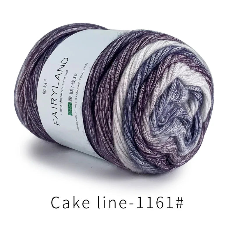 A skein of Fairyland long distance cake blue and white gradient yarn for knitting or crochet.