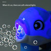 A close-up of a blue whale bubble gun emitting soft colored lights and bubbles.