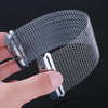 A hand holds a metal wire strand for snare drums or cajons, showing the mesh texture and silver color.