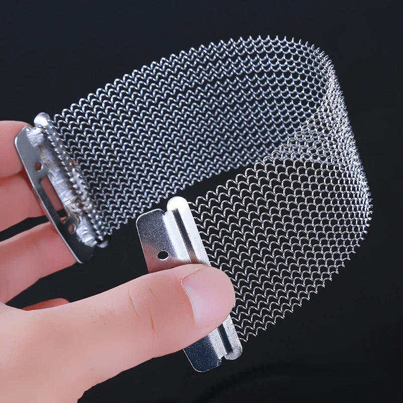 A hand holds a metal wire strand for snare drums or cajons, showing the mesh texture and silver color.
