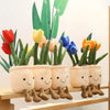 A collection of soft, plush tulip succulent stuffed toys in various colors like red, yellow, orange, and blue, displayed on a
