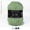 A ball of light green milk cotton yarn labeled with Chinese characters and a size designation.