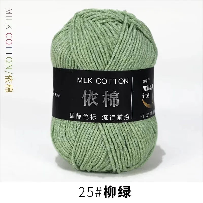 A ball of light green milk cotton yarn labeled with Chinese characters and a size designation.